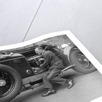 Geoffrey Baker inspecting the engine of a Minerva car by Bill Brunell