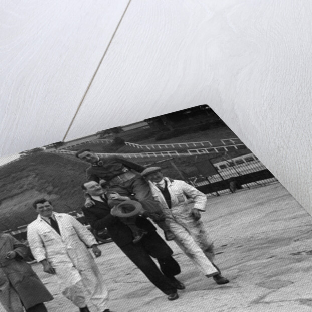 Leon Cushman being carried aloft after making a successful speed record attempt, Brooklands, 1931 by Bill Brunell