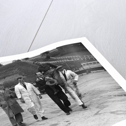 Leon Cushman being carried aloft after making a successful speed record attempt, Brooklands, 1931 by Bill Brunell