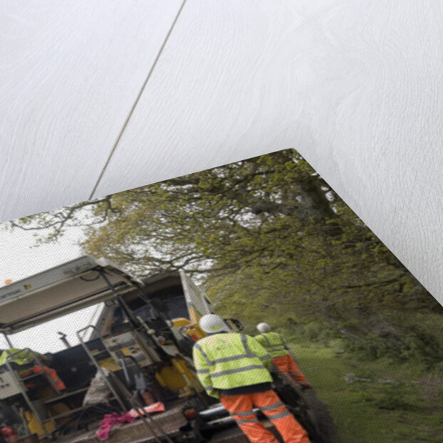 Road resurfacing work repairing potholes by Unknown