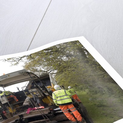 Road resurfacing work repairing potholes by Unknown