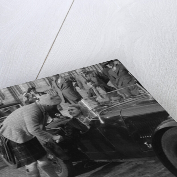 Kitty Brunell in her Aston Martin, chatting to a man in Highland dress, RSAC Scottish Rally, 1933 by Bill Brunell