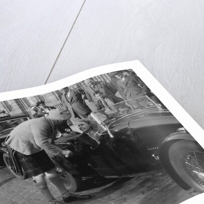 Kitty Brunell in her Aston Martin, chatting to a man in Highland dress, RSAC Scottish Rally, 1933 by Bill Brunell