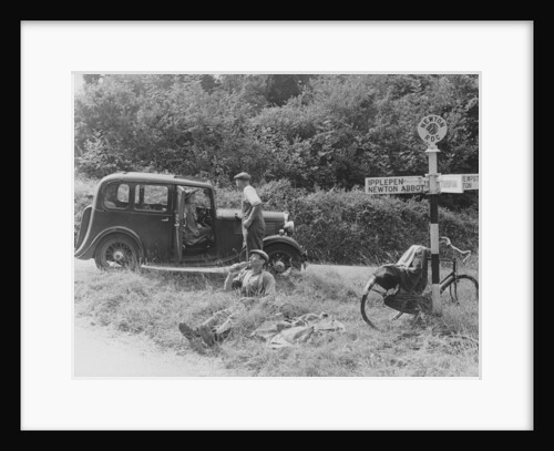 People relaxing by a signpost with a 1935 Standard 10 hp car, Devon, (c1935?) by Unknown