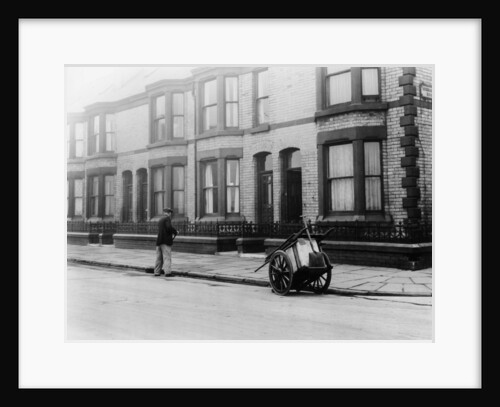 An 'Orderly Boy' and his cart sweeping a street, Liverpool, 1935 by Unknown