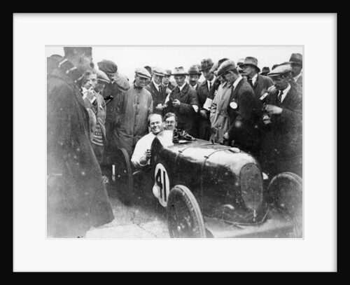 Gordon Taylor in a racing car surrounded by a crowd of men by Unknown