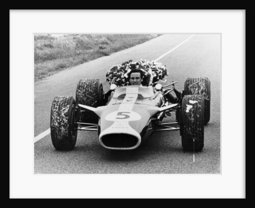 Jim Clark in a Lotus with the winner's laurel wreath by Unknown