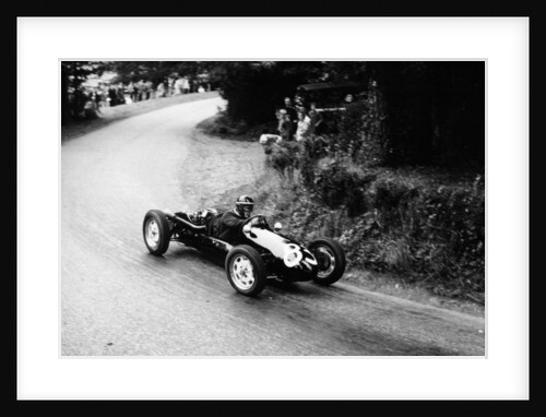 A racing driver speeding round a bend by Anonymous