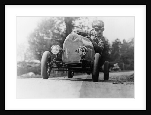 Boy in a pedal car by Unknown