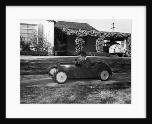 Boy in a pedal car by Unknown