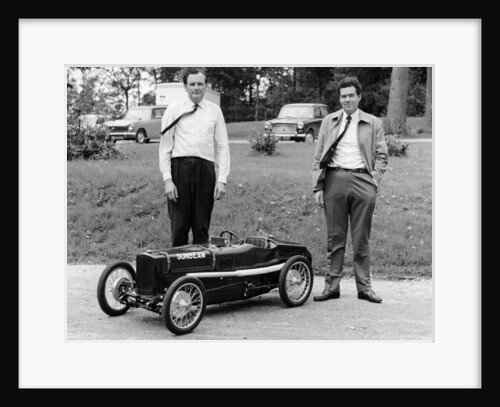 Two men standing by a miniature Sunbeam pedal car, 1960s by Unknown
