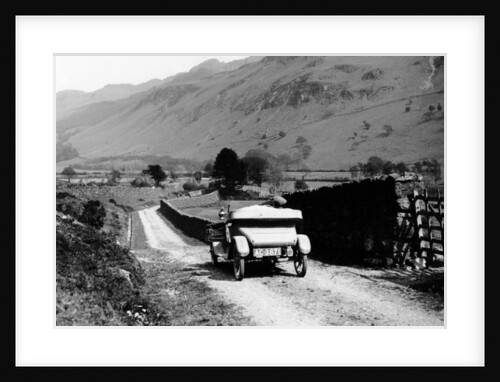 A vintage car travelling along a lane through the Lake District, Cumbria, 1920s by Unknown