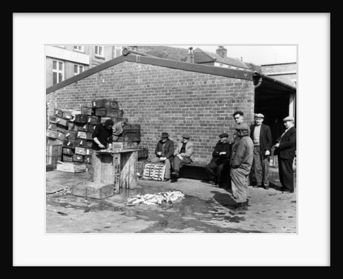 Gutting fish outside a warehouse in Whitby, North Yorkshire, 1959 by Unknown