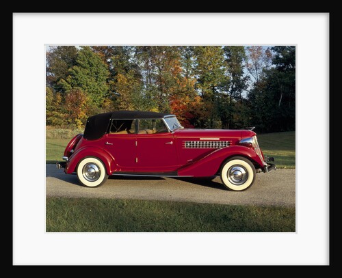A 1936 Auburn 852 car on a gravel driveway in the autumn sunlight by Unknown
