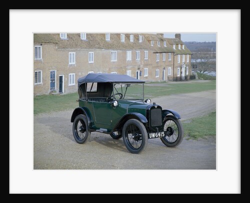 A 1929 Austin 7 in front of a row of terraced houses by Unknown