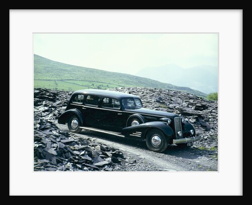 A 1937 Cadillac V16 sedan, photographed among piles of slate by Unknown