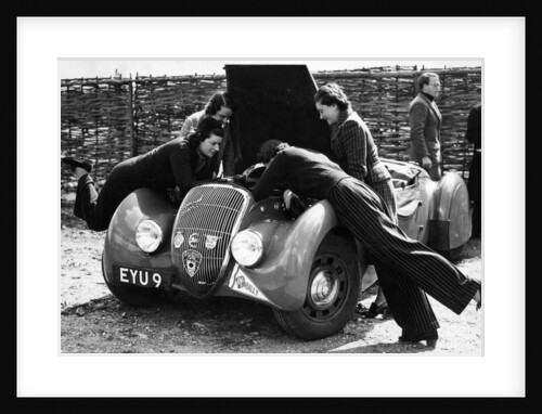 Miss MD Patten looking at the engine of a 1938 Peugeot 402 Special Sport, RAC Rally, 1939 by Unknown