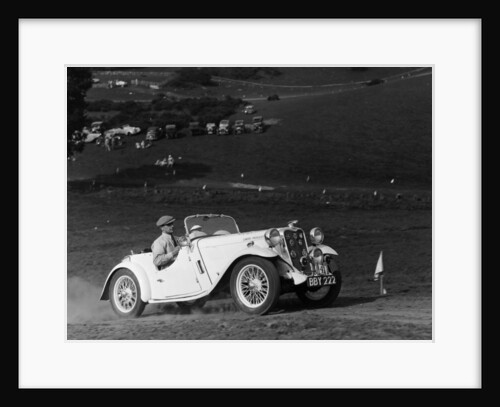 A Singer Nine Le Mans climbing a hill by Anonymous