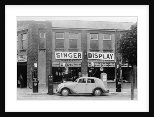 A Singer 11hp Airstream saloon car outside a Welsh garage, Wales, 1935 by Unknown