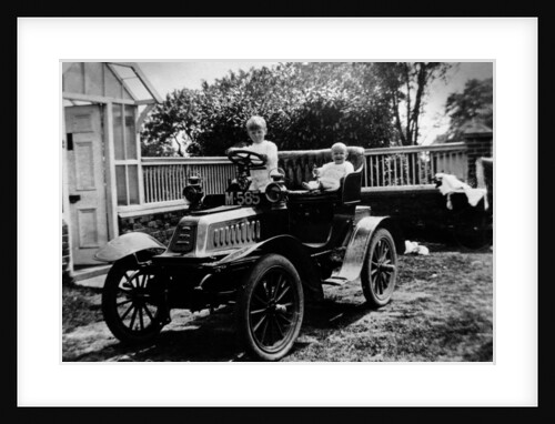 A child at the wheel of a De Dion Bouton car by Anonymous