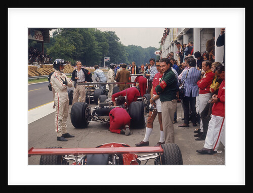 Graham Hill watches Mechanics working on a car, French Grand Prix, Rouen, 1968 by Unknown