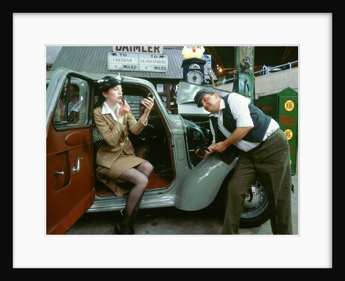 Mechanic with lady driver doing her make up, 1930's Hillman Minx by Unknown