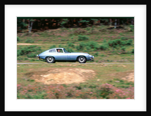 1965 Jaguar E type with smiling driver by Unknown