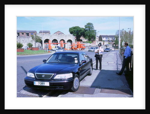 Policeman checking driver documents by Unknown