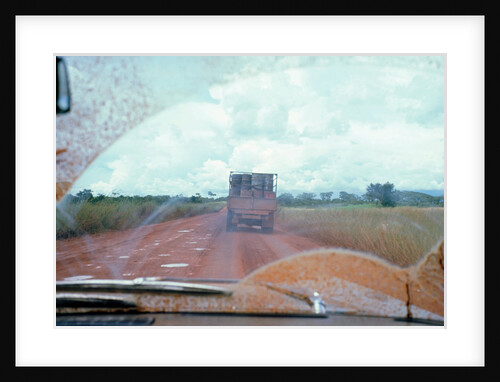 View through muddy windsreen on African dirt road by Unknown