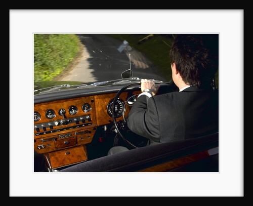 Chauffeur driving 1970 Daimler vanden plas DS 420 limousine by Unknown