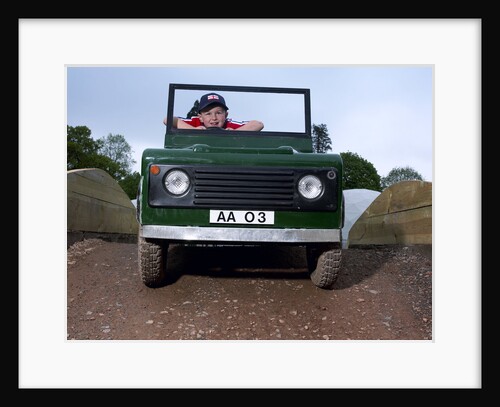 Children driving a toy Land Rover by Unknown