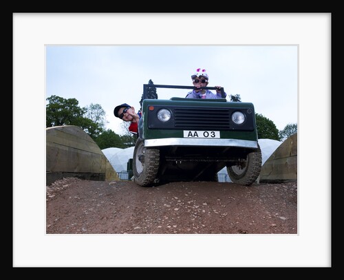 Child driving a toy Land Rover by Unknown