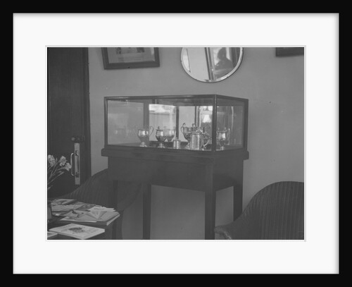 Cabinet containing motor racing trophies by Bill Brunell