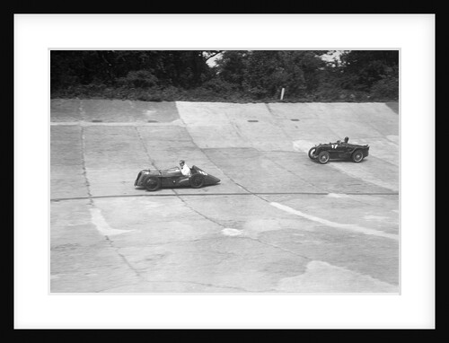Austin 747 cc with sreamlined racing body leading an MG C type on the Members Banking at Brooklands by Bill Brunell