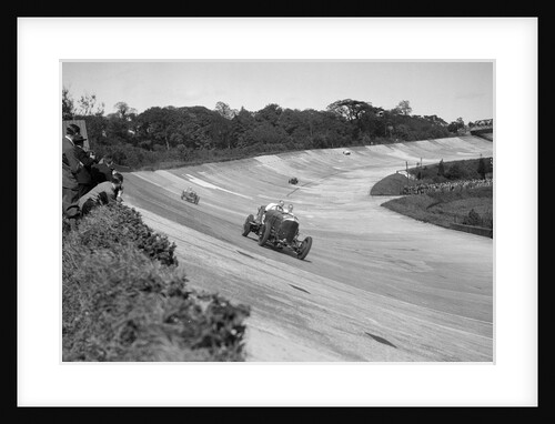 Eddie Hall's Bentley leading a Bugatti on the banking at Brooklands. by Bill Brunell