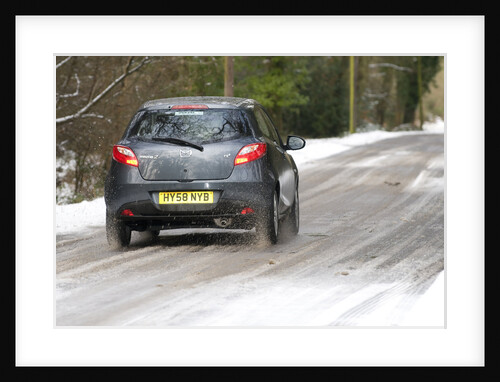 2009 Mazda 2 driving on snowy road by Unknown