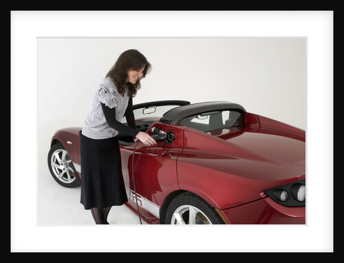 2010 Tesla Roadster electric car being re charged by Unknown