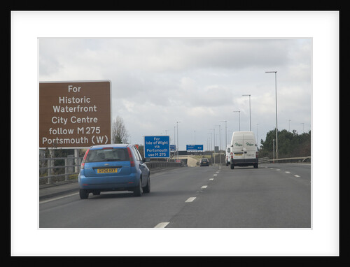 Traffic on M27 Motorway with brown tourist information sign by Anonymous