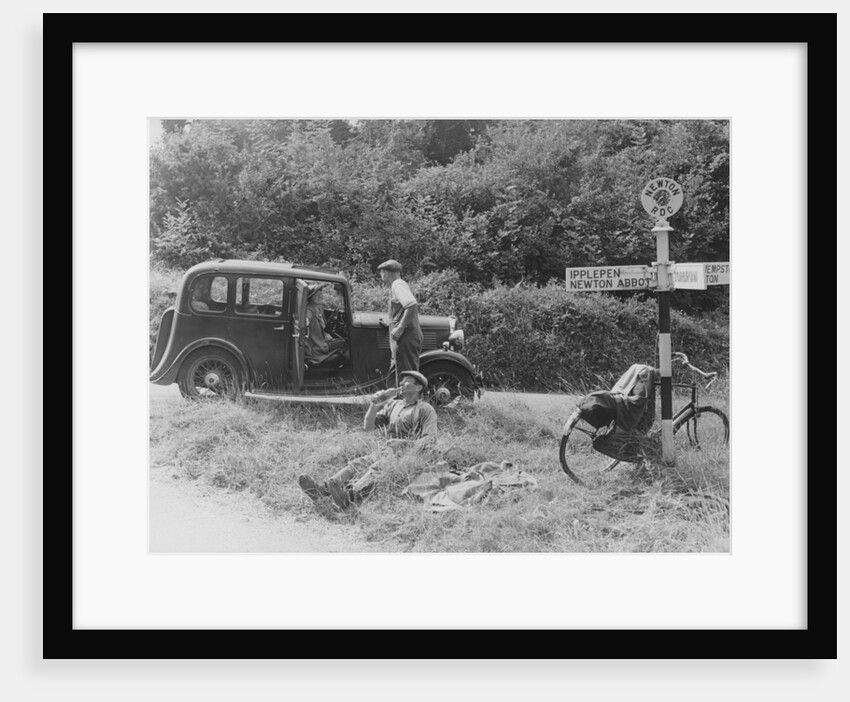 People relaxing by a signpost with a 1935 Standard 10 hp car, Devon, (c1935?) by Unknown