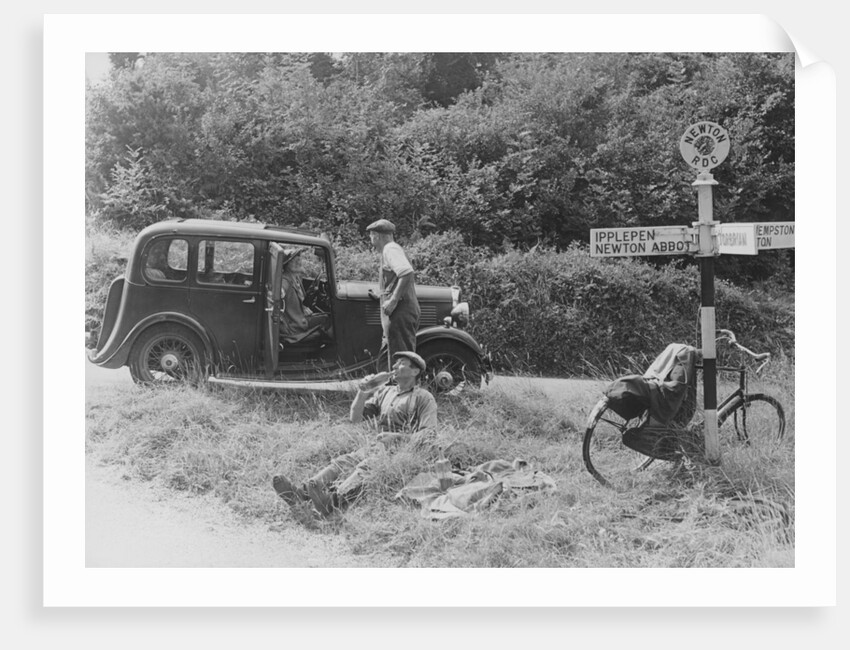 People relaxing by a signpost with a 1935 Standard 10 hp car, Devon, (c1935?) by Unknown