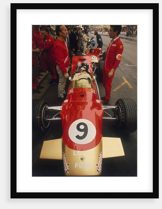 Colin Chapman and a mechanic in discussion over Graham Hill's Lotus by Anonymous