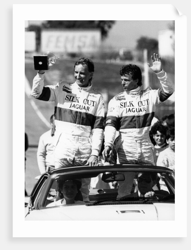 John Watson and Jan Lammers waving at the crowds at Jarama, Spain, 1987 by Unknown