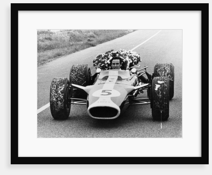 Jim Clark in a Lotus with the winner's laurel wreath by Unknown