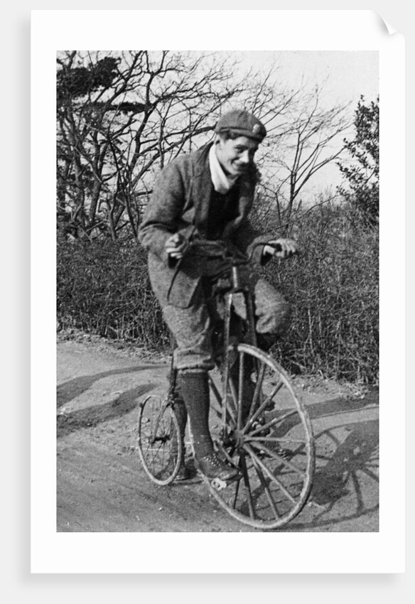 A young Lord Nuffield riding a bicycle down a country lane by Unknown