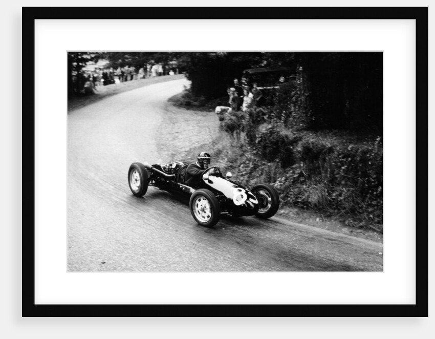 A racing driver speeding round a bend by Anonymous