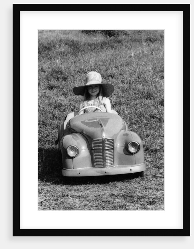 Girl in a 1948 vintage Austin J40 pedal car by Unknown