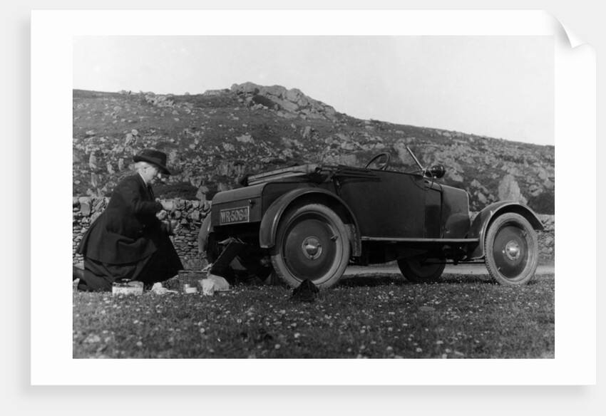 A woman picnicking next to her air-cooled Rover 8, c1919-c1925 by Unknown