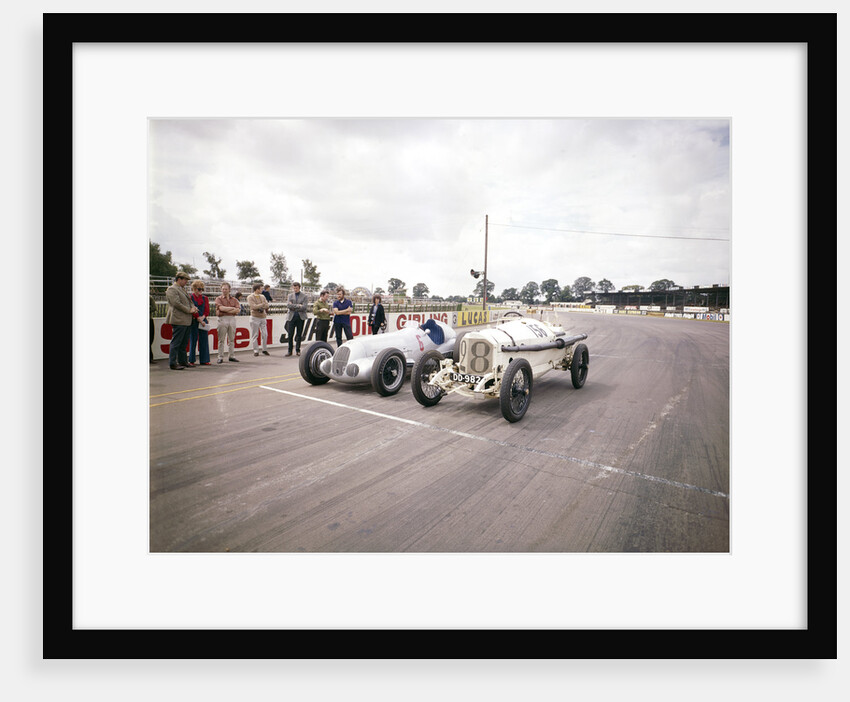 A 1914 and 1937 Grand Prix Mercedes racing cars at the starting line by Unknown