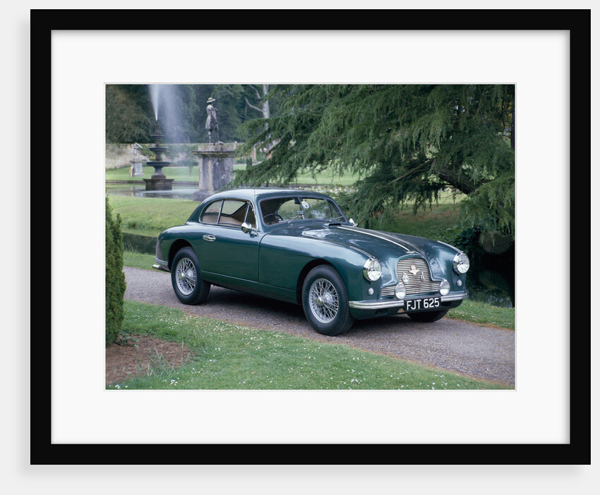 A 1952 Aston Martin DB2 saloon car photographed in a stately garden by Unknown