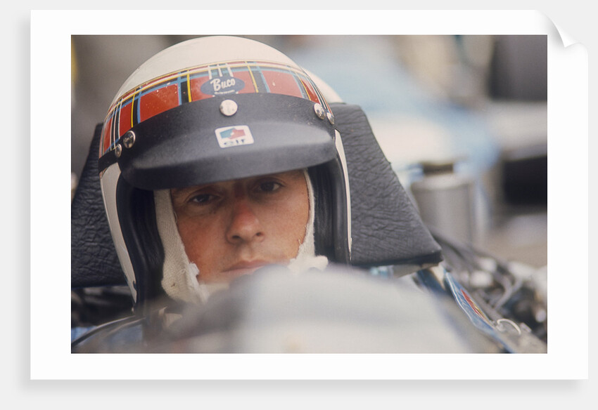 Jackie Stewart at the wheel of a racing car by Unknown